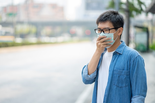 Man wearing face mask protect filter against air pollution (PM2.5)