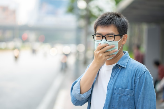 Man wearing face mask protect filter against air pollution (PM2.5)