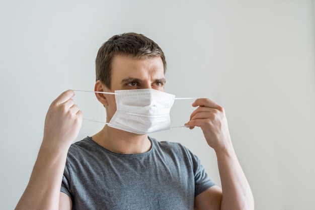 Man wearing facial hygienic mask. Ecology, air pollution, Environmental awareness and virus protection concept. Coronavirus prevention