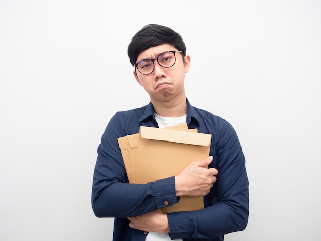 Man wearing glasses holding envelope feeling sad