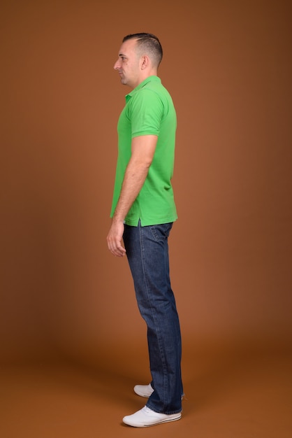 man wearing green shirt on brown