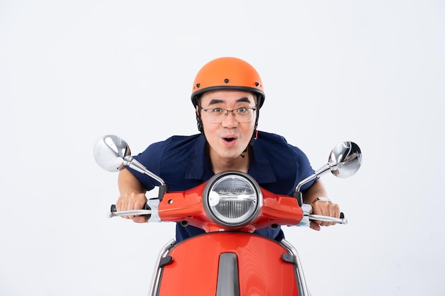 a man wearing a helmet and driving a motorcycle