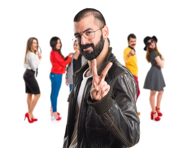 Man wearing a leather jacket doing victory gesture