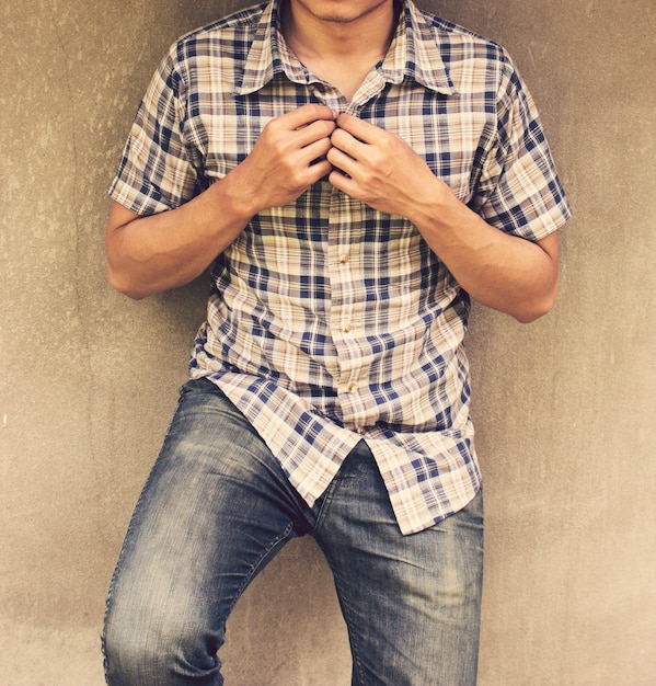 Man wearing a plaid shirt and jeans 