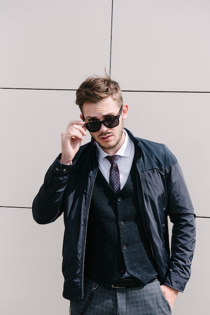 Man wearing suit and tie posing. Advertising menswear.