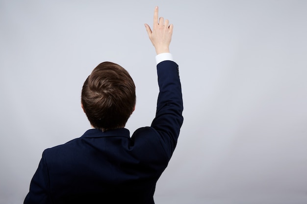 Man wearing suit  wall pointing on desk, business concept, copy space, portrait.