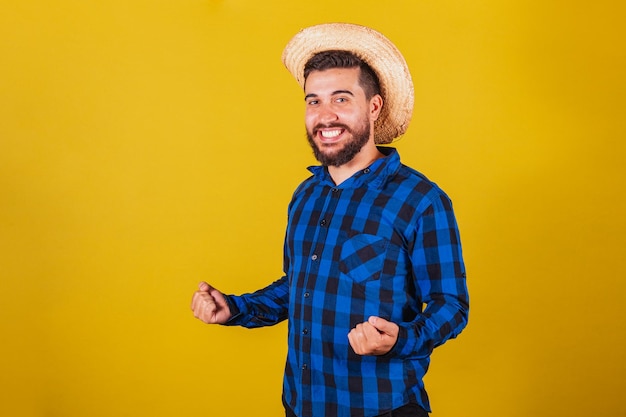 Man wearing typical clothes for Festa Junina Celebrating supporter victory