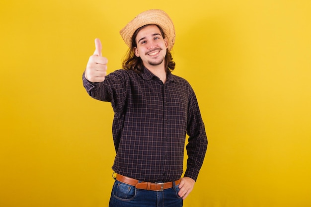 Man wearing typical clothes for party Junina Thumb up positive approved affirmative