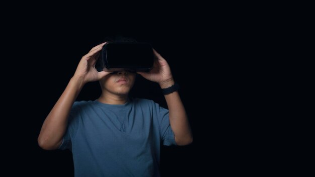 Man wearing virtual reality Headset on black background VR future technology online concept Glasses of virtual reality and exploring the metaverse Technology gaming entertainment concept