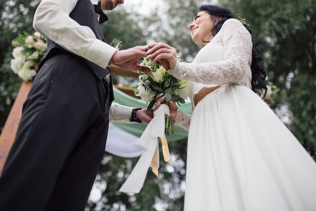 A man wearing a wedding ring on his wife's finger.