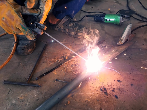 Man welding steel blurred on black background