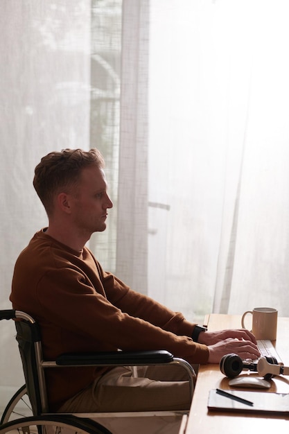 Man in Wheelchair Working on Computer