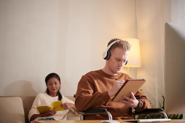 Man in Wheelchair Working from Home