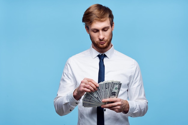 Man in white shirt bundle of money wealth dollars finance