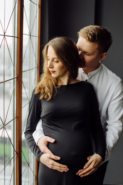 Man in white shirt and female in black dress Pregnancy photo