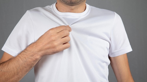 Man in a white tshirt at grey background