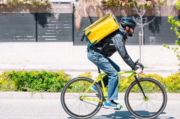 Man who works delivering food by courier at high speed through the city.