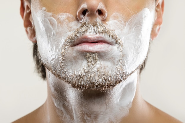 Man with applied shaving cream on his face