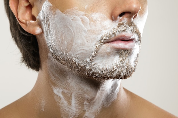 Man with applied shaving cream on his face