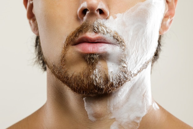 Man with applied shaving cream on his face