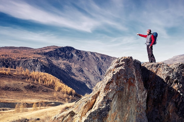 Man with backpack hiking in mountains Travel Lifestyle success concept