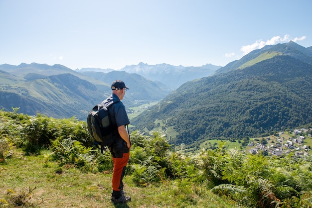 Man with backpack hiking in Pyrenees Mountains