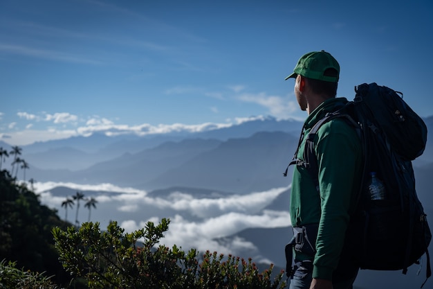 Man with backpack looking at mountain view. Travel and adventure concept. High quality photo