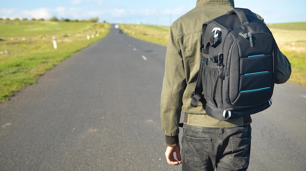 Man with backpack standing on the road