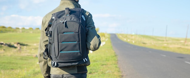 Man with backpack standing on the road