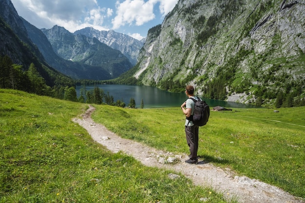 Man with backpack on summer hike around hinterer Gosausee Salzkammergut Austria