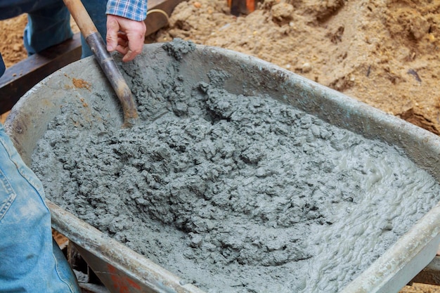 Man with barrow full of ground work in garden