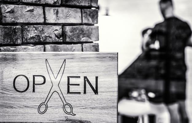 Man with beard in barber shop Open barbershop salon Modern hair salon Black and white