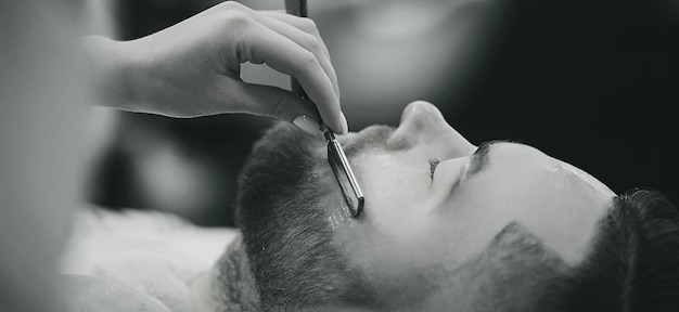 Man with a beard on a chair in the barbershop