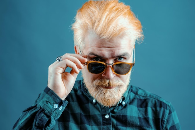 Man with beard and glasses feeling confident bearded man with fashion sunglasses studio shot of youn