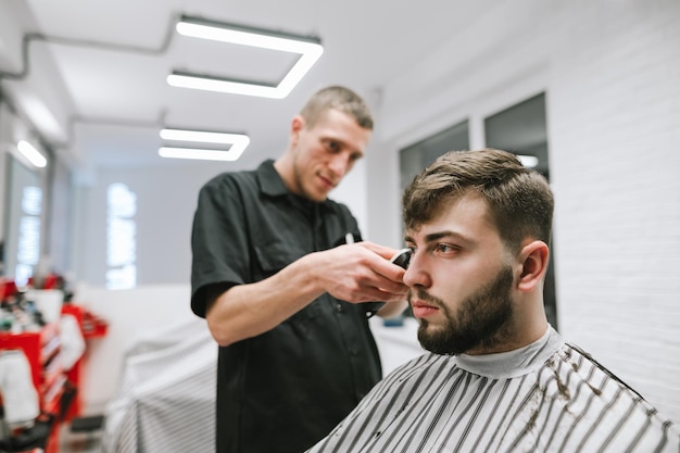 Man with beard and hair care in barbershop Haircut in a professional barber