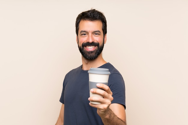 Man with beard holding a coffee with happy expression