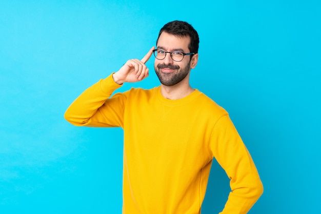 Man with beard over isolated blue wall