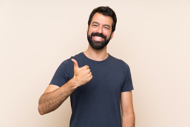 Man with beard with thumbs up because something good has happened