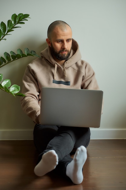 A man with a beard working on his laptop