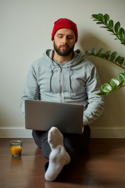 A man with a beard working on his laptop