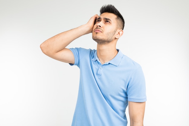 Man with a blue shirt thinking about an idea on a white isolated background