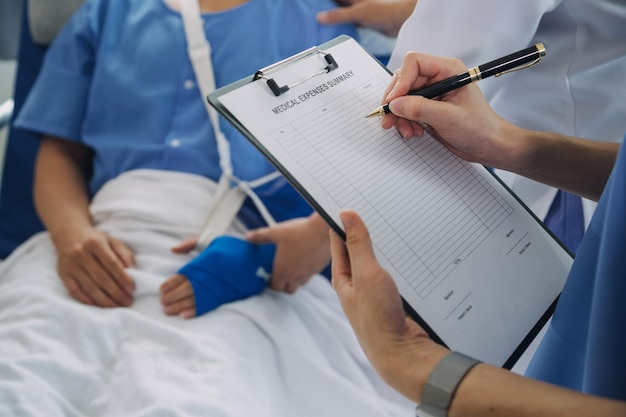 Man with broken arm in cast lying on bed in hospital The emergency center treatment is plaster and hangs with sling for a further cure in an orthopedic clinic Patient pain from accident injury