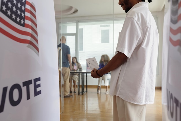 Man with bulletin voting during election