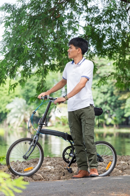 Man with cargo pants riding a bicycle in the garden