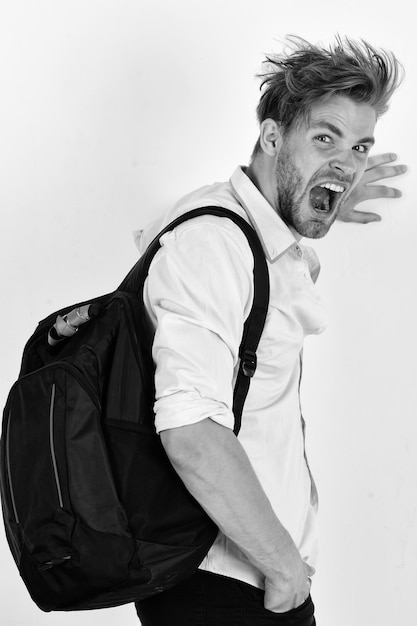 Man with cheerful face wears backpack isolated on white background