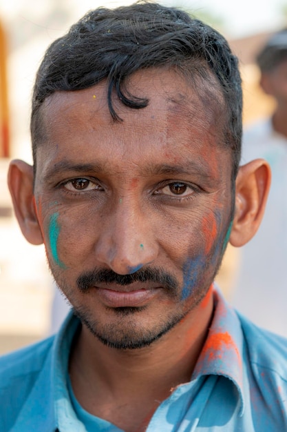 A man with colorful paint on his face