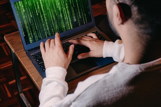 Man with computer screen with green binary matrix binary