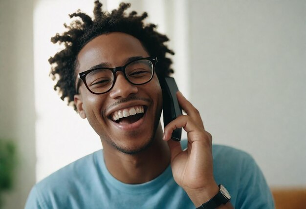 a man with curly hair and glasses is talking on a cell phone