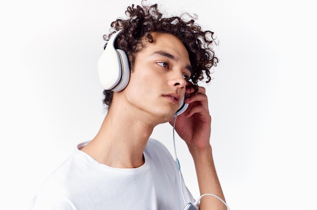 Man with curly hair wearing headphones music emotions closeup