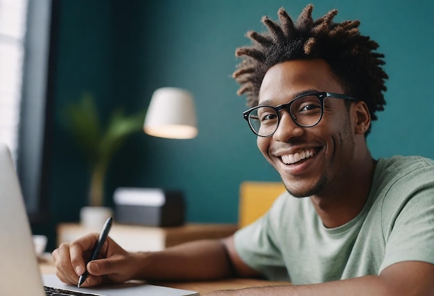 a man with dreadlocks is writing in a notebook